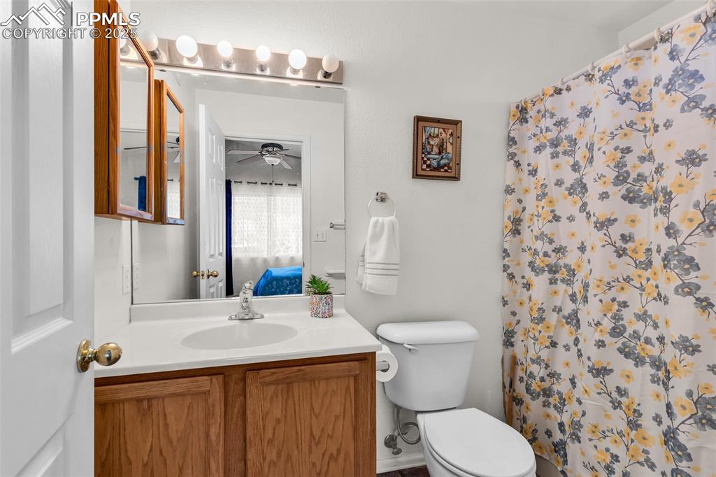 Image 12 of 20: Full bath with vanity, a ceiling fan, and a shower with shower curtain