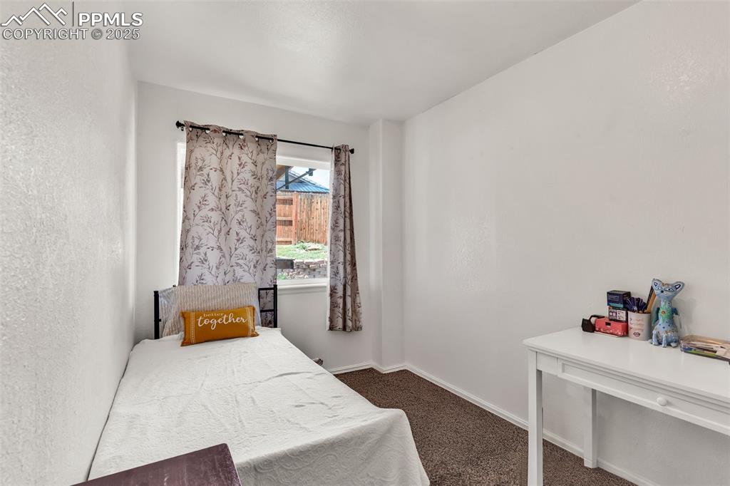 Image 14 of 20: Carpeted bedroom with baseboards