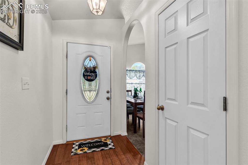 Image 3 of 20: Foyer with dark wood-type flooring and baseboards
