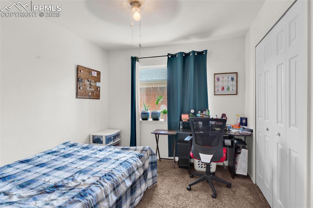 Image 9 of 20: Bedroom with carpet, a closet, and a ceiling fan