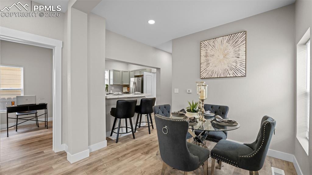 Image 10 of 36: Dining room featuring light wood-style floors and recessed lighting