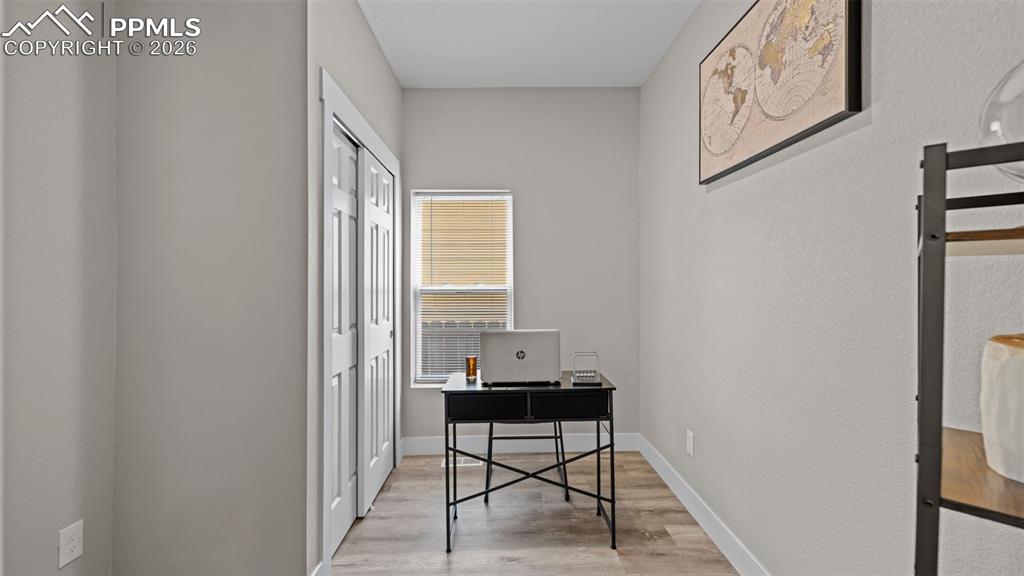 Image 11 of 36: Office with light wood-style floors and baseboards