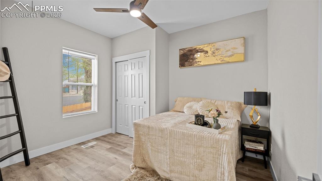 Image 13 of 36: Bedroom featuring light wood-style flooring, a ceiling fan, and a closet