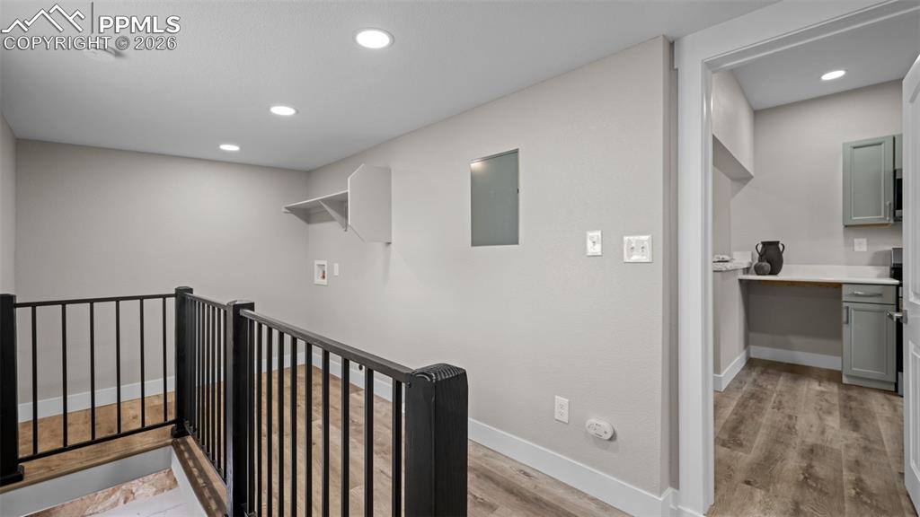 Image 20 of 36: Stairway featuring recessed lighting, wood finished floors, and electric pa