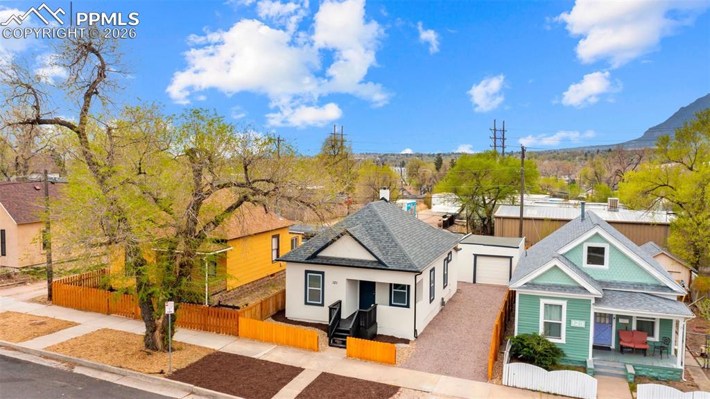Image 28 of 36: View of front facade featuring a fenced front yard, a shingled roof, a resi