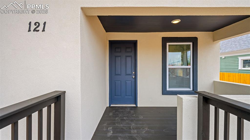 Image 4 of 36: Doorway to property with stucco siding