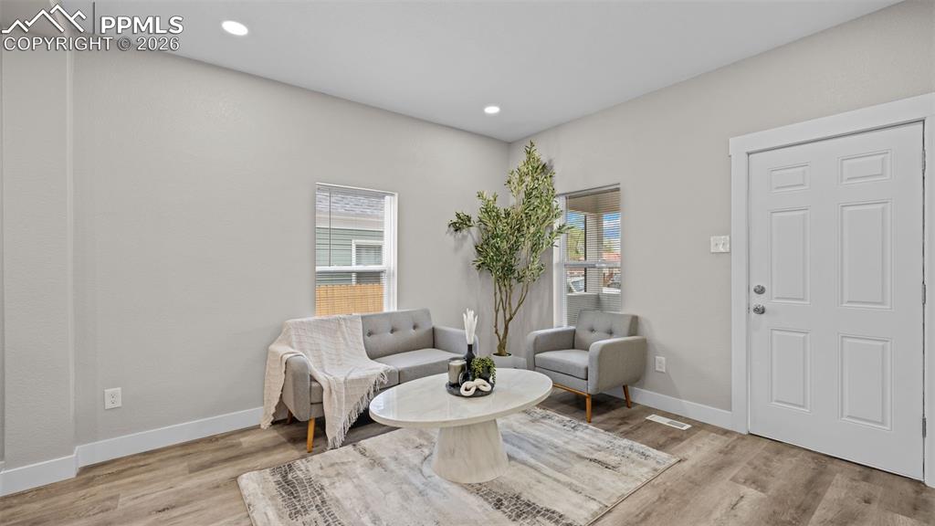 Image 6 of 36: Sitting room with light wood-style flooring and recessed lighting