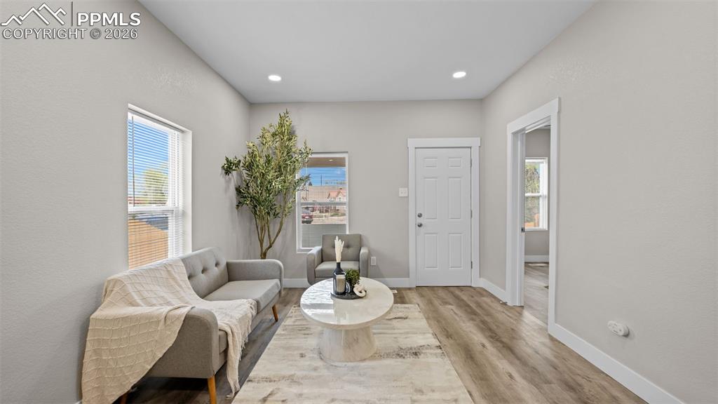 Image 8 of 36: Sitting room with light wood-style flooring, healthy amount of natural ligh