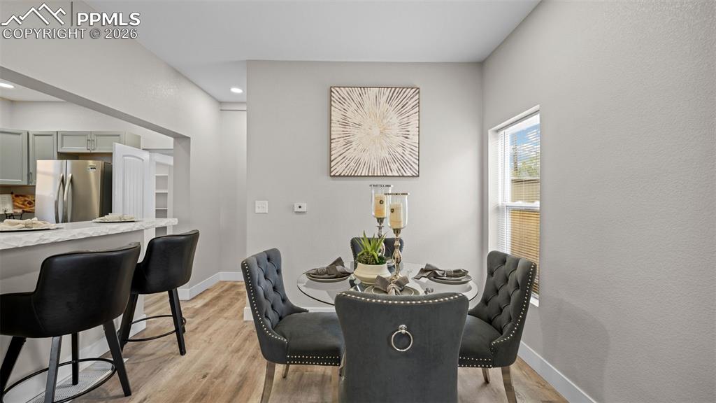 Image 9 of 36: Dining space featuring baseboards and light wood-style floors