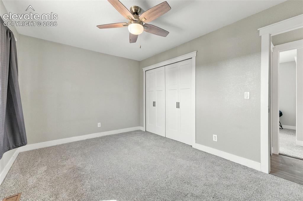 Image 16 of 46: wood-finish ceiling fan, and carpeted flooring