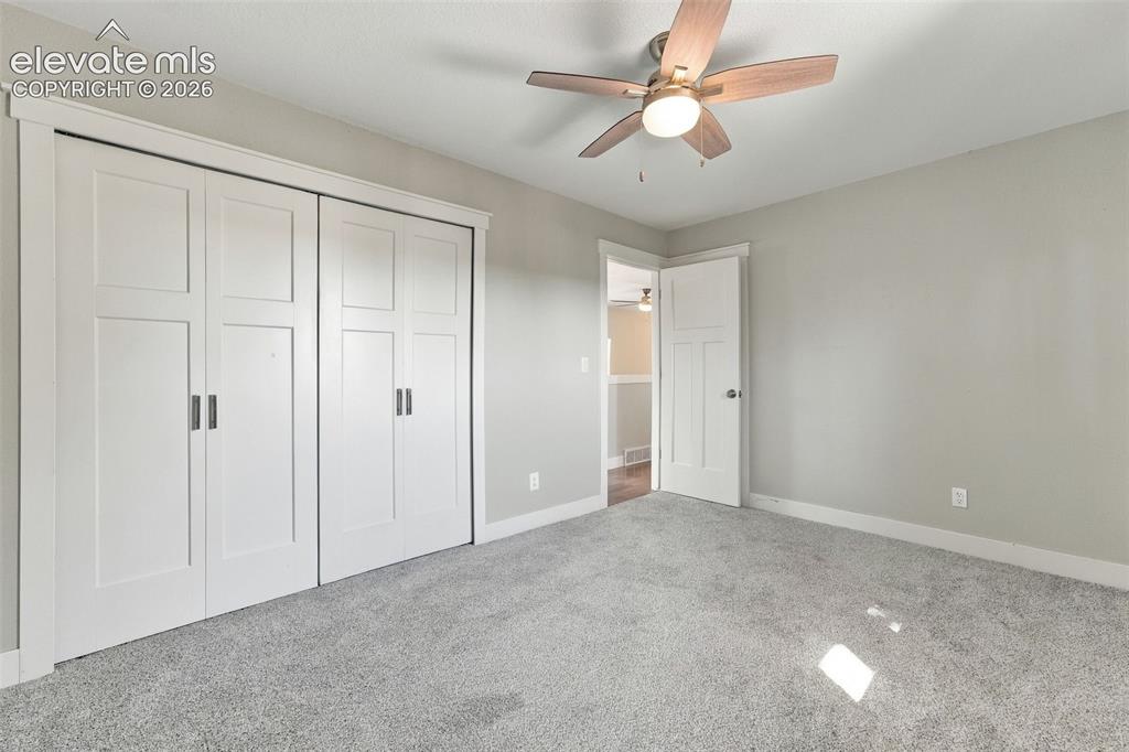 Image 18 of 46: Neutral-toned walls complement the light gray carpeting