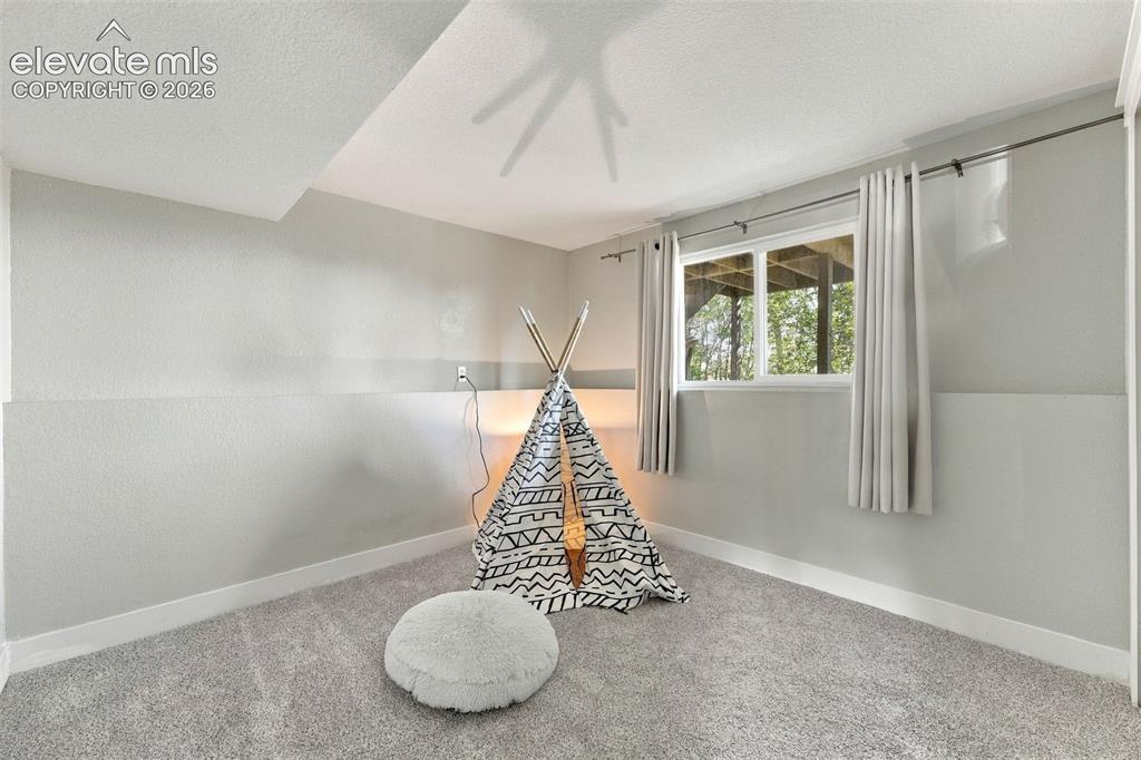 Image 20 of 46: Recessed window with white trim, gray textured walls, and light gray carpet