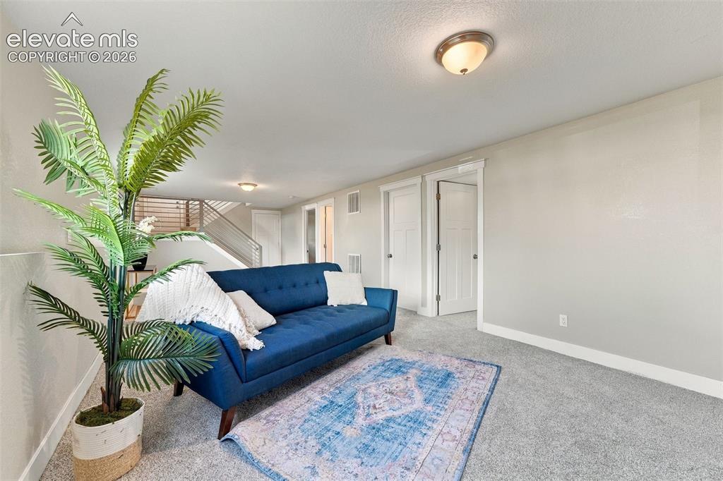Image 29 of 46: Light gray wall finishes, recessed lighting, white baseboards, gray carpet