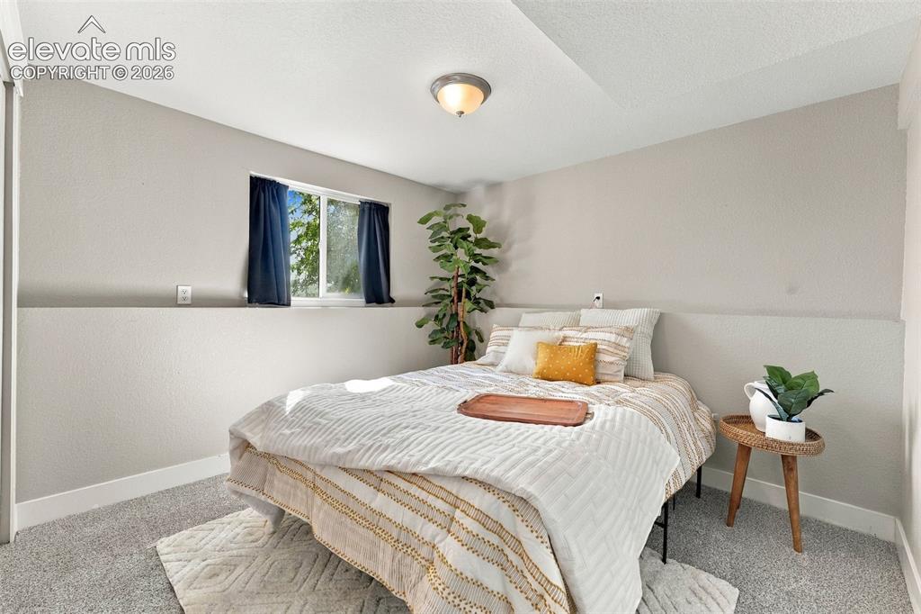 Image 30 of 46: Recessed window, textured walls, overhead lighting, and carpeted flooring