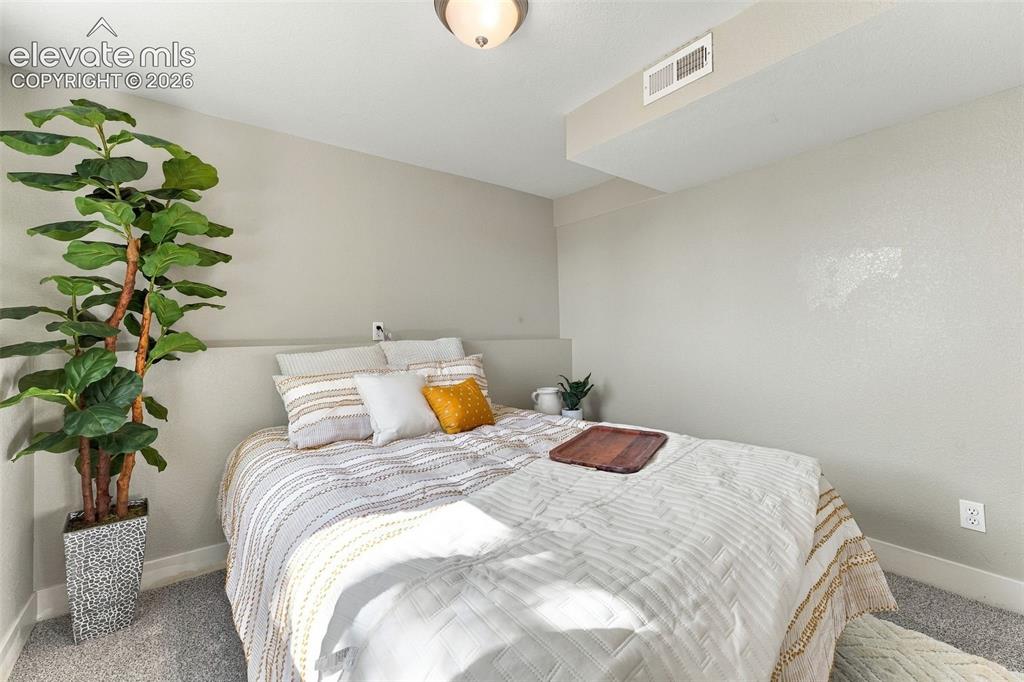 Image 31 of 46: Neutral wall tones, recessed ceiling lighting, and soft gray carpeting