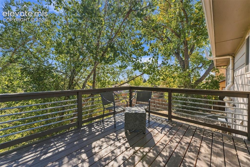 Image 34 of 46: Outdoor deck featuring composite decking, a horizontal cable railing system