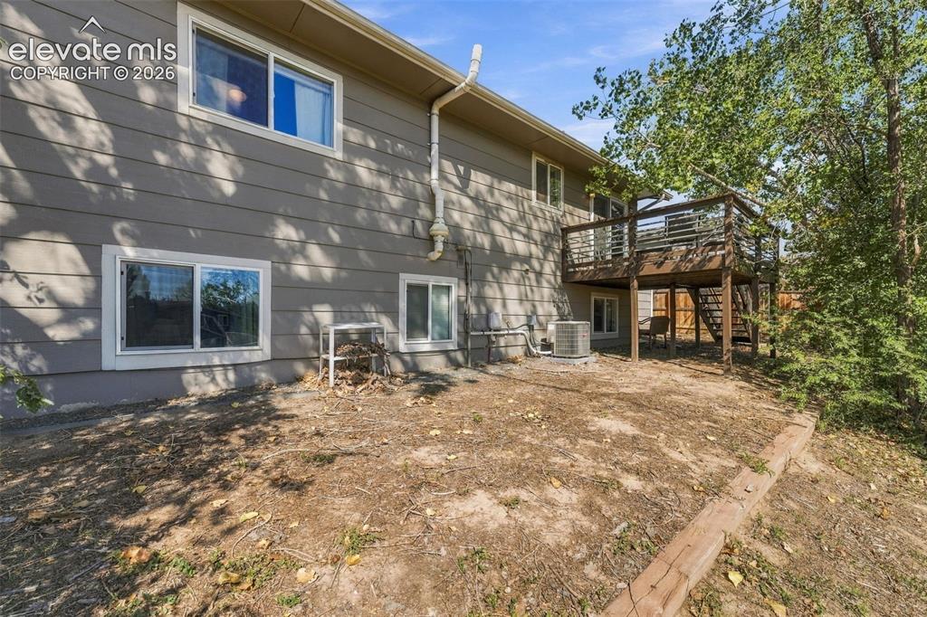 Image 37 of 46: Two-story exterior with horizontal siding, multiple windows, and a raised w