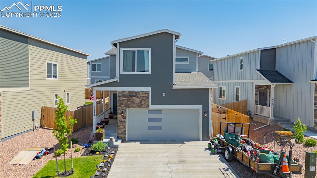 Image 35 of 35: Contemporary house featuring driveway, a garage, roof with shingles, and st