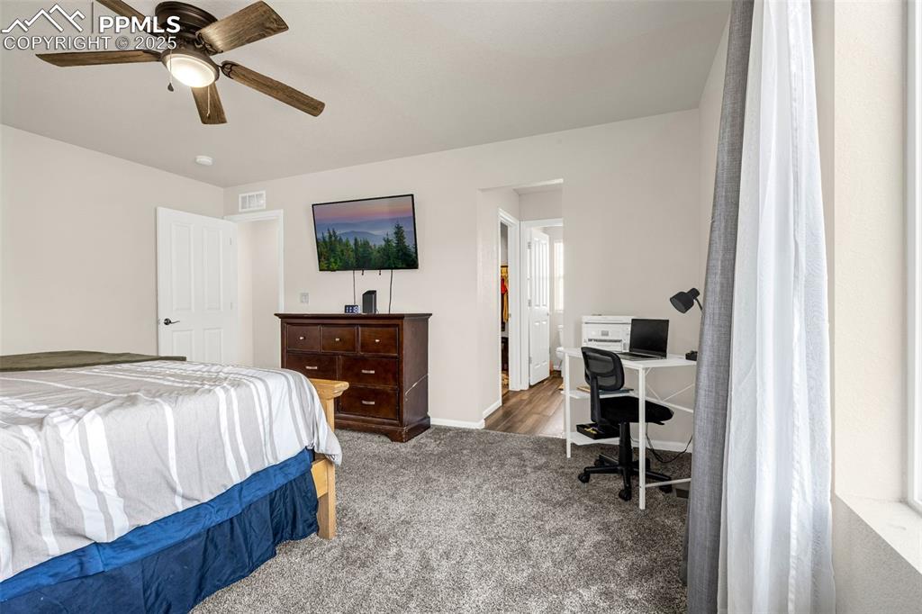 Image 8 of 35: Bedroom with carpet flooring, an office area, and ceiling fan