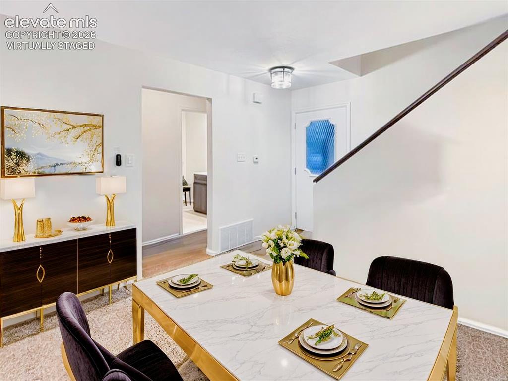 Image 11 of 44: Virtually Staged Dining area featuring a contemporary table with a marble-l