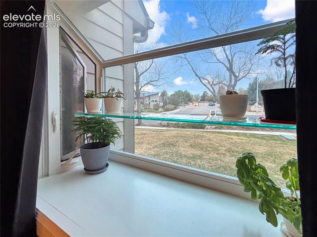 Image 16 of 44: Double-paned window with a white frame and sill, featuring a clear glass sh