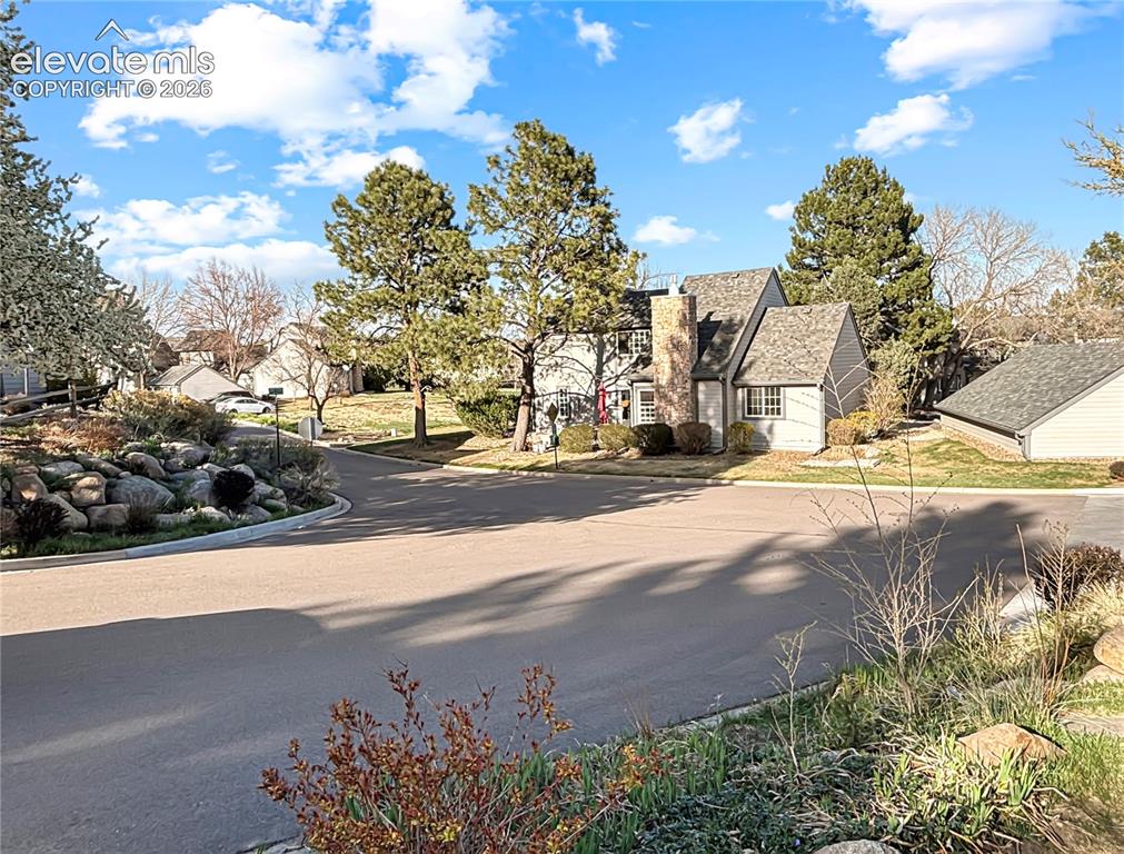 Image 20 of 44: Exterior featuring gabled rooflines, a prominent brick chimney, and a multi