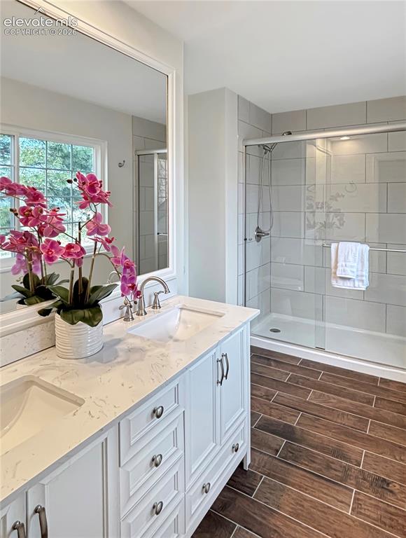Image 36 of 44: Dual vanity with integrated sinks, white cabinetry, and brushed nickel hard