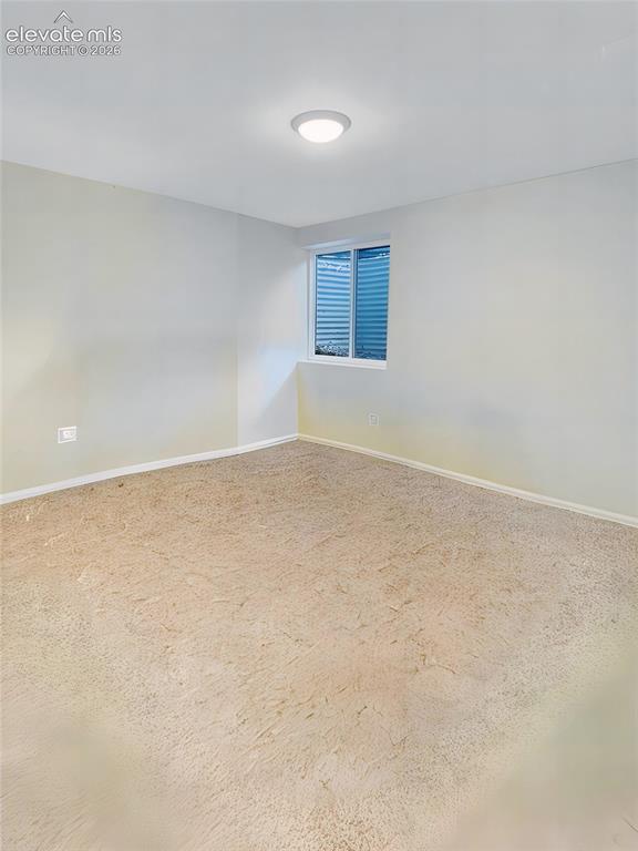 Image 40 of 44: Cream-toned carpeting in a neutral room featuring a single window