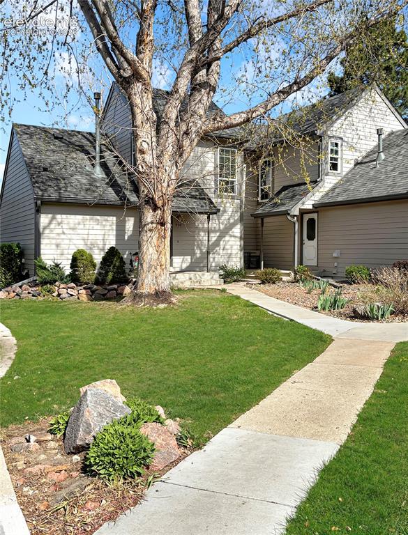 Image 42 of 44: Light-colored siding exterior with dark shingle roofing
