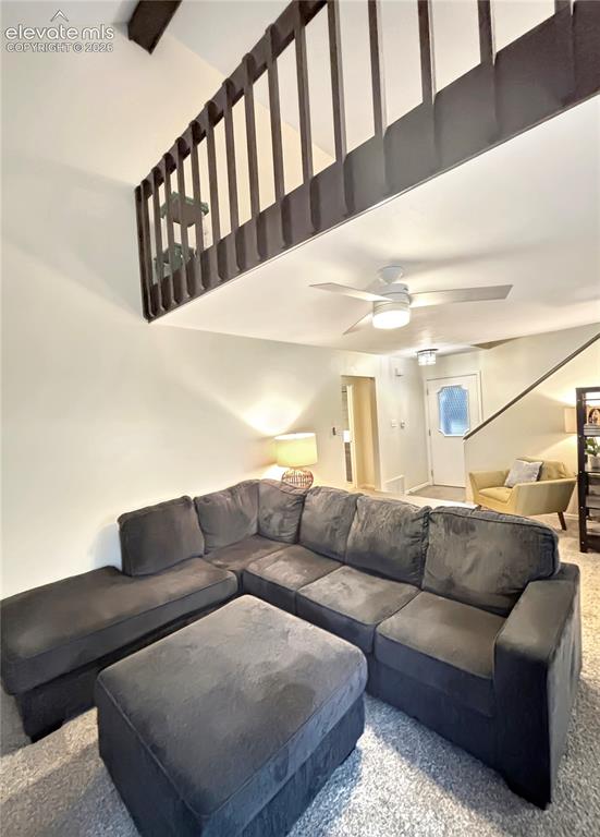 Image 9 of 44: Vaulted ceiling with exposed beam, lofted area with dark wood railing, and