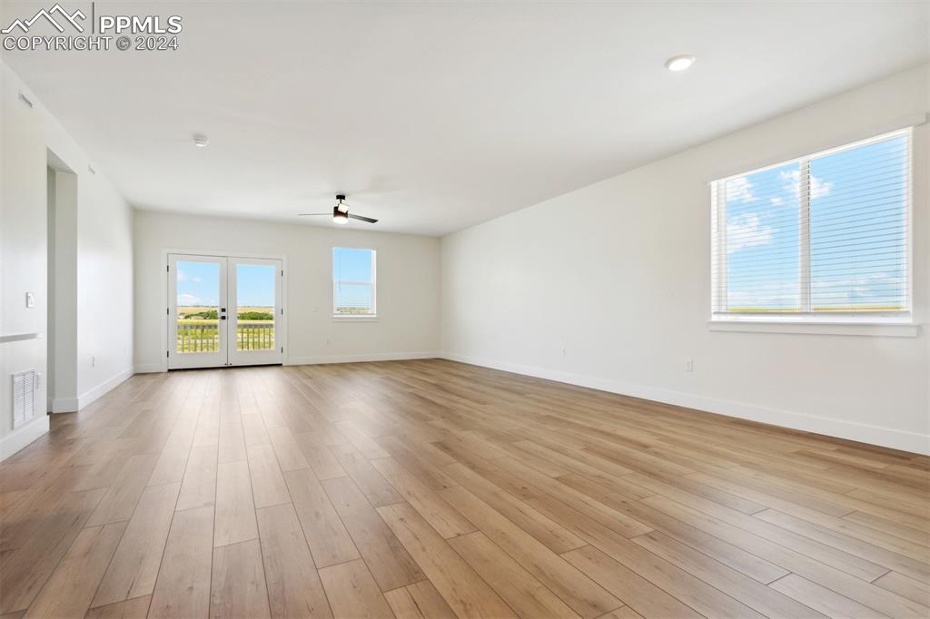 Image 4 of 15: Unfurnished room featuring ceiling fan, french doors, and light wood-type f