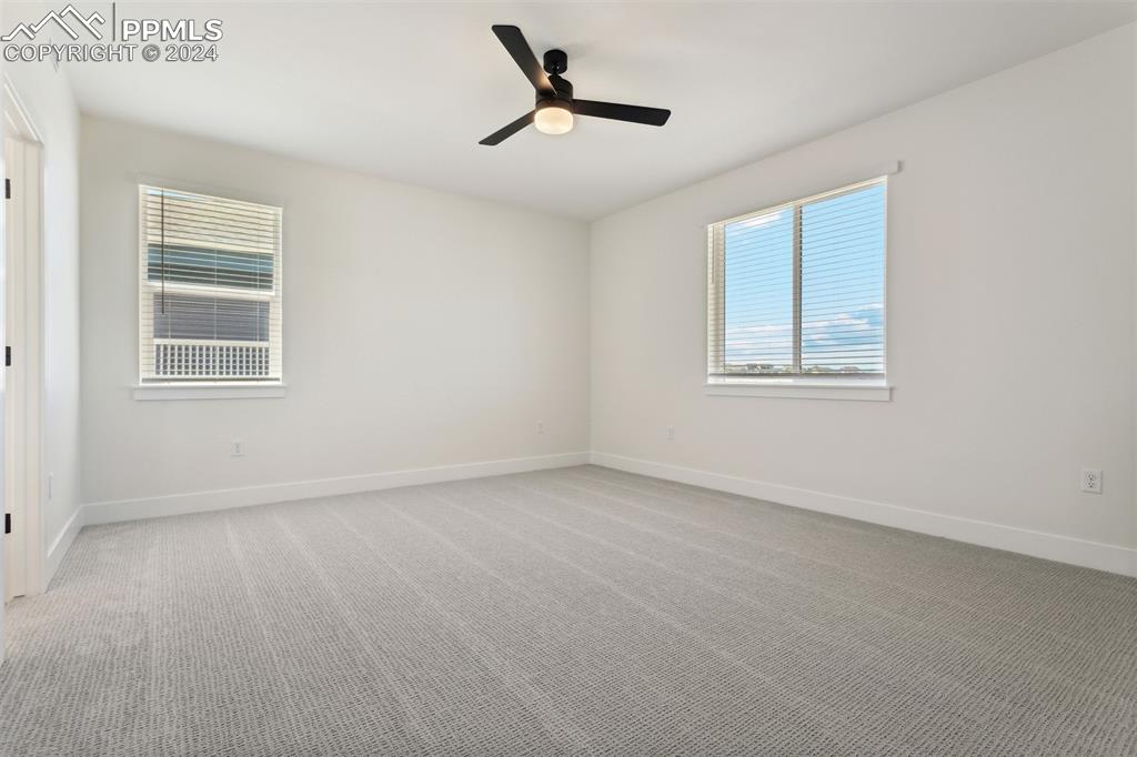 Image 6 of 15: Spare room featuring light carpet and ceiling fan