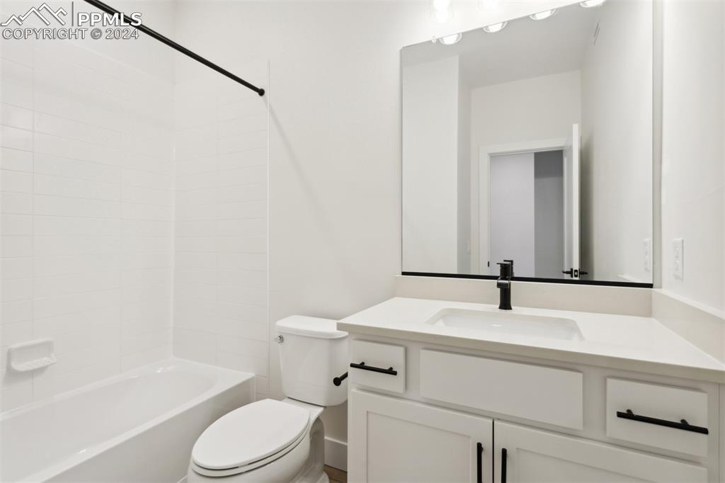 Image 9 of 15: Full bathroom with vanity, toilet, and washtub / shower combination