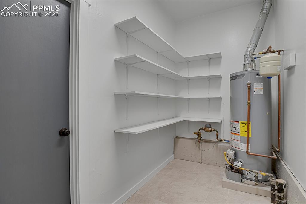 Image 33 of 40: Main level laundry room with additonal storage