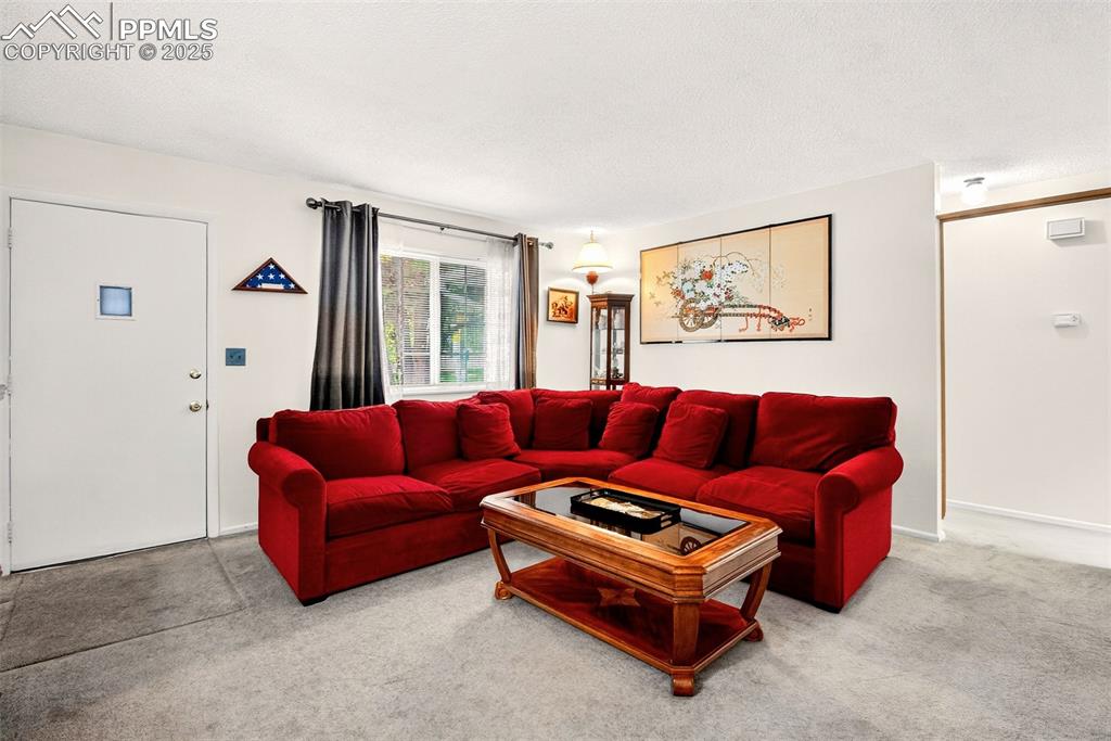 Image 3 of 37: Living room view from entryway. Couch is included if you like it :~)