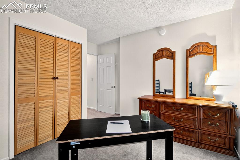 Image 31 of 37: Office space featuring light carpet and a textured ceiling