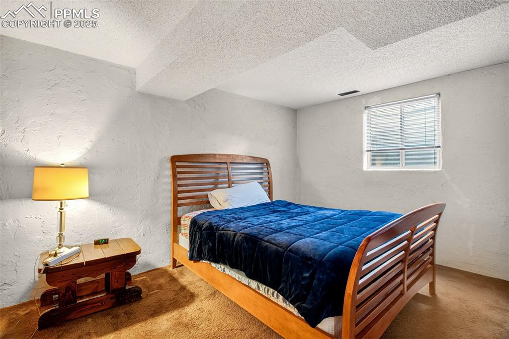 Image 33 of 37: Basement bedroom