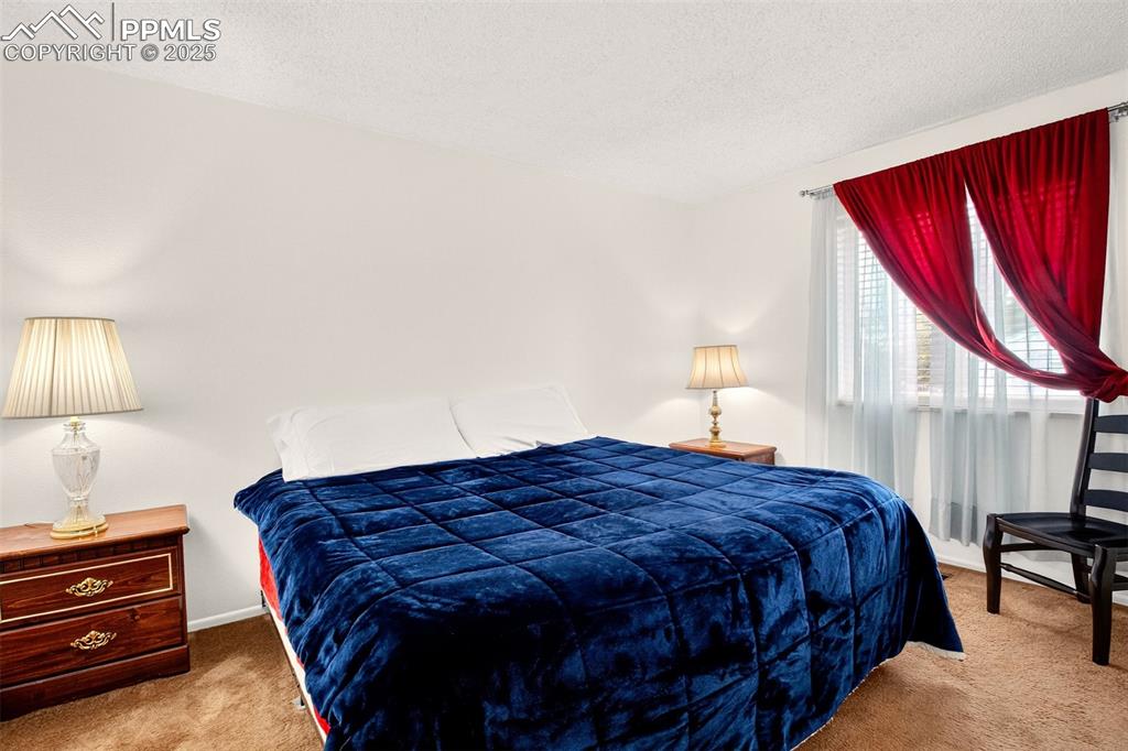 Image 5 of 37: Carpeted bedroom featuring a textured ceiling