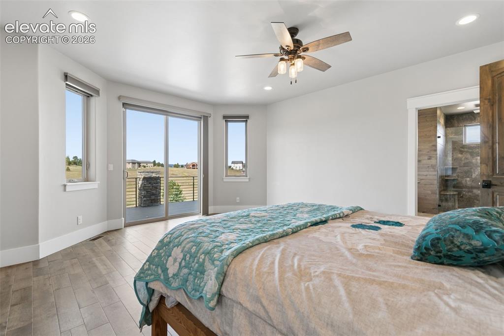 Image 24 of 50: Wood-finish flooring, recessed lighting, and a ceiling fan with integrated 