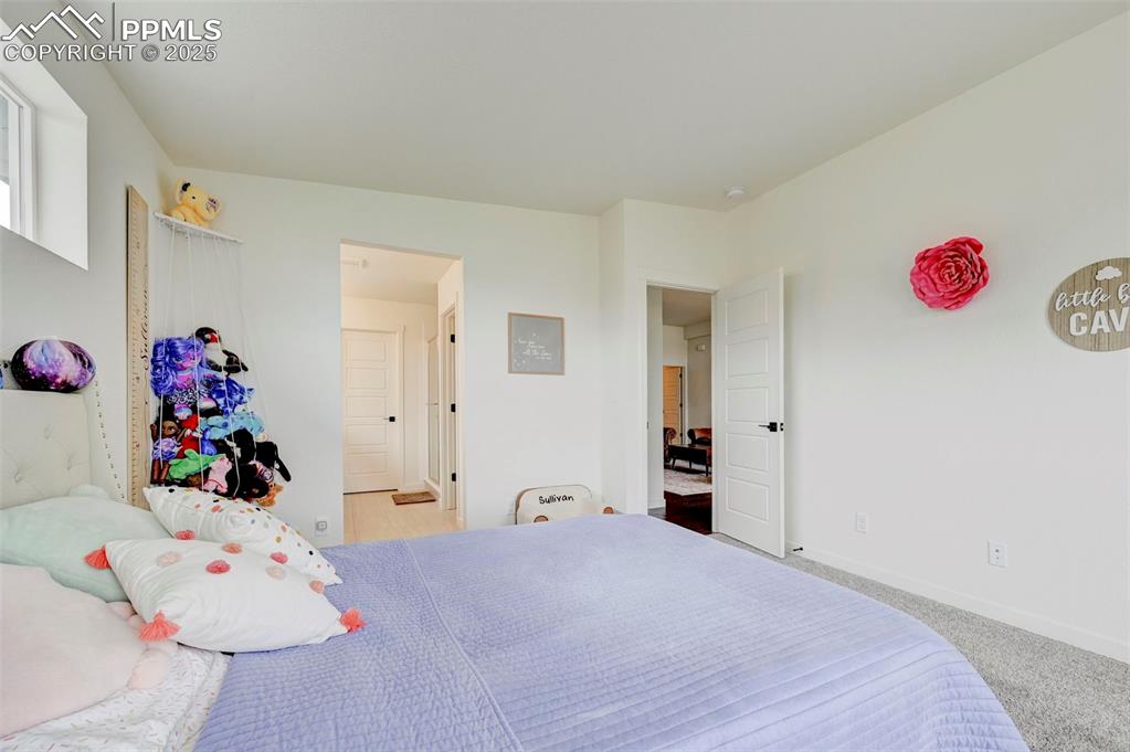Image 19 of 48: Carpeted bedroom featuring baseboards