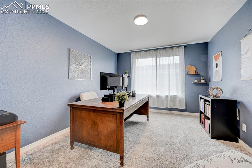Image 21 of 48: Carpeted office featuring baseboards and a textured wall