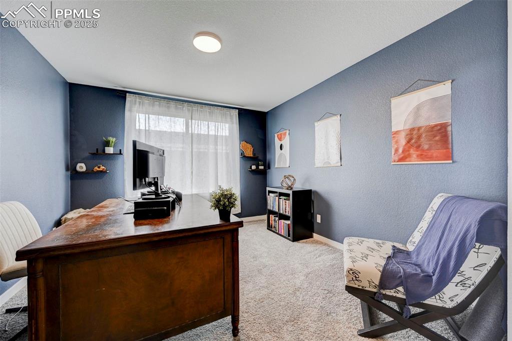 Image 22 of 48: Carpeted office space featuring baseboards