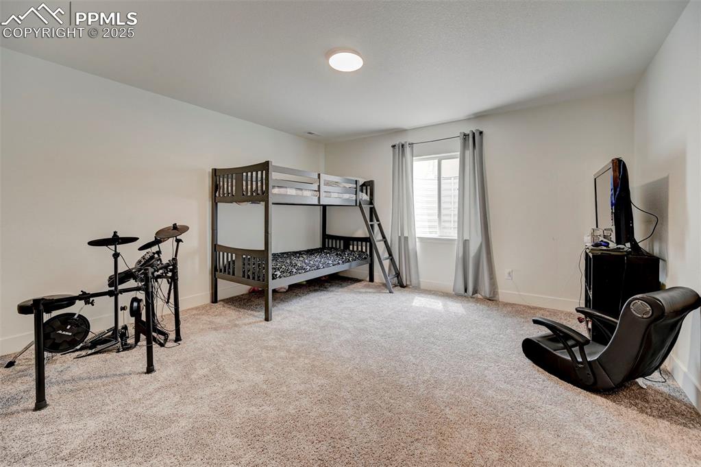 Image 37 of 48: Carpeted bedroom with baseboards