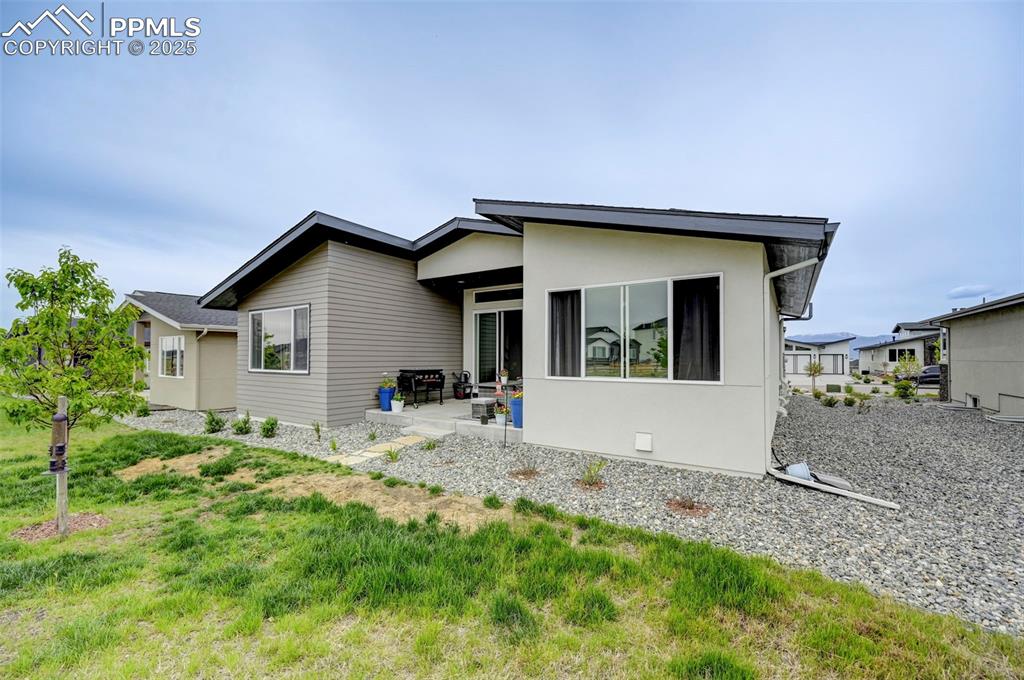 Image 48 of 48: Back of property with a patio area and stucco siding