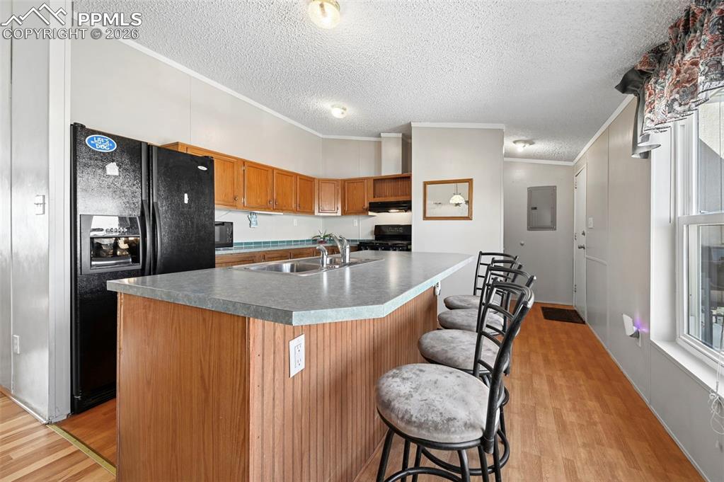 Image 17 of 47: Country Eat in Wood Floors in Living Room, Kitchen and Dining area