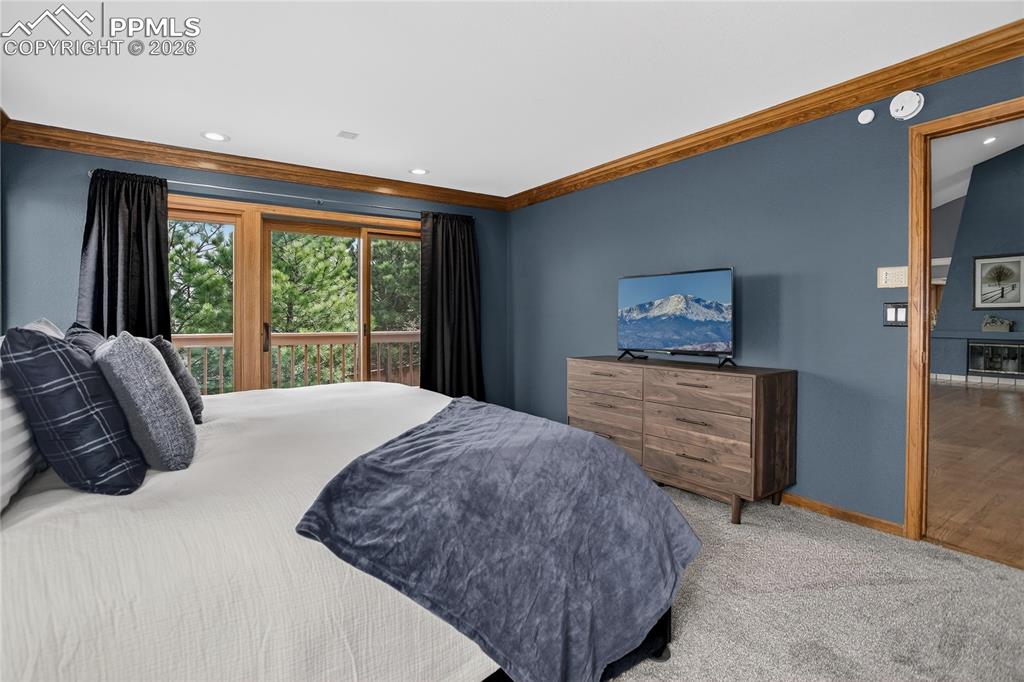 Image 17 of 42: Bedroom with carpet flooring and ornamental molding