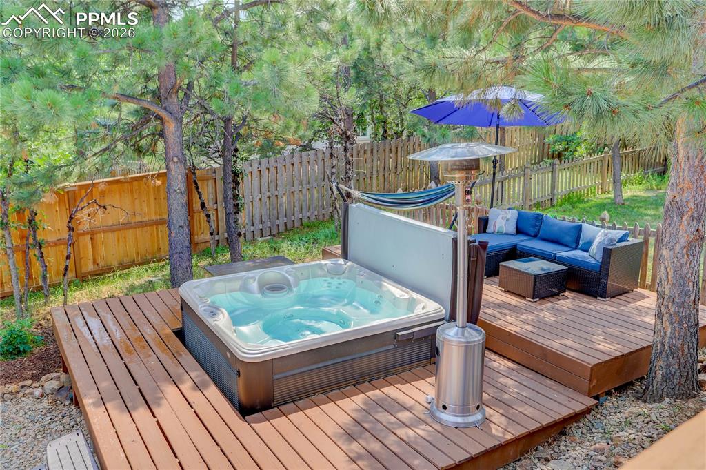 Image 33 of 42: Outdoor entertainment space with hot tub