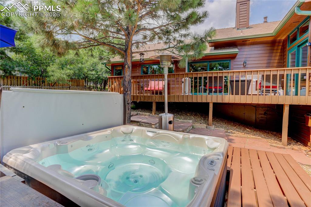 Image 34 of 42: Wooden deck featuring a covered hot tub