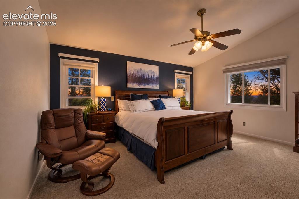 Image 23 of 50: Carpeted room featuring a vaulted ceiling with a ceiling fan, a dark accent