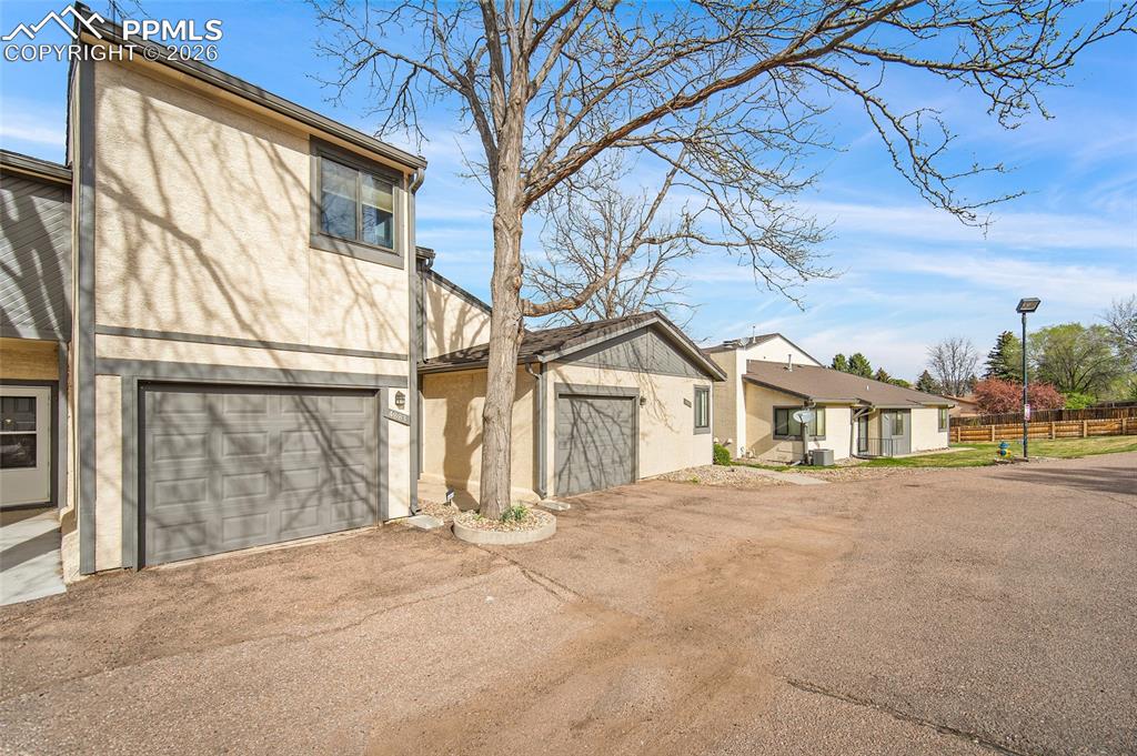 Image 2 of 31: View of front facade featuring stucco siding and driveway